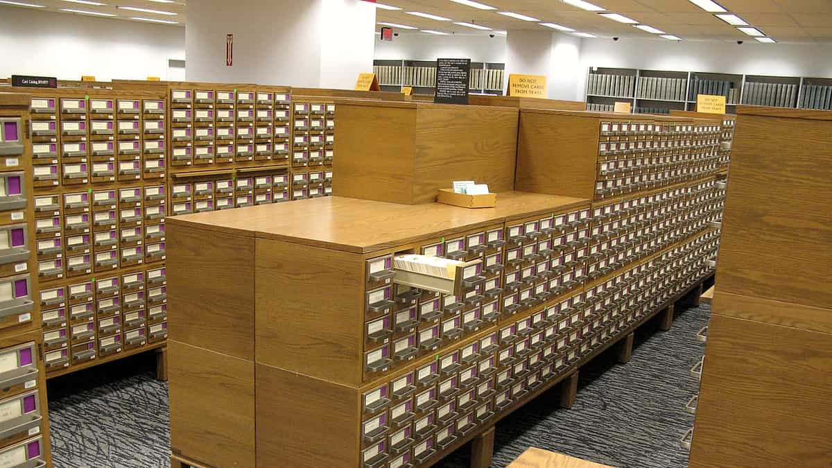 A hardbound ledger open on a counter with a fountain pen laid across the right-hand page